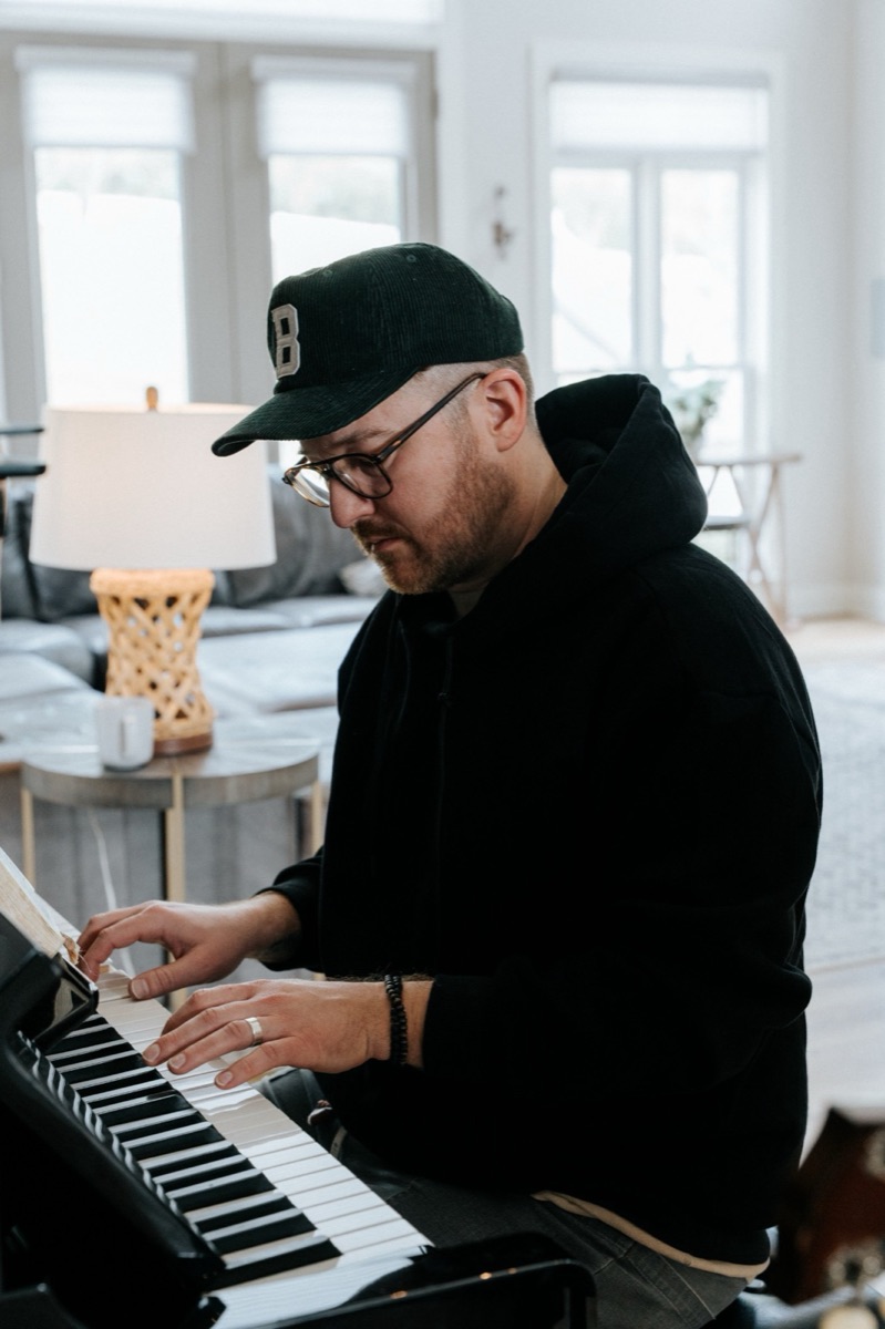 Landon at the piano, working out a part